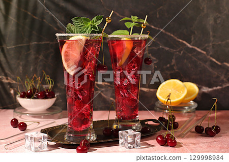 Sangria or cocktail with mint, cherry, soda, lemon and ice, a recipe for a refreshing summer and autumn drink, a detox diet and weight loss concept, a restaurant and bar menu. Cold homemade lemonade Sangria or cocktail with mint, cherry, soda, lemon and ice, a recipe for a refreshing summer and autumn drink, a detox diet and weight loss concept, a restaurant and bar menu. Cold homemade lemonade 129998984