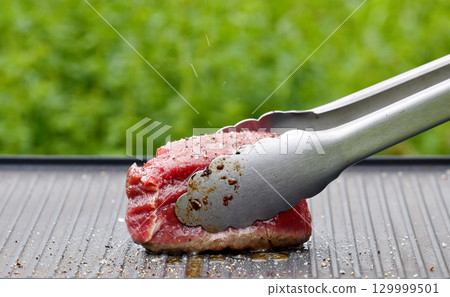cook preparing fresh raw beef fillet mignon steak cook preparing fresh raw beef fillet mignon steak 129999501