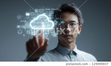 Asian man interacting with digital cloud technology interface in a modern workspace environment 129999937