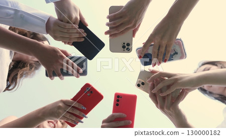A diverse collection of hands holding various models of smartphones, symbolizing connectivity in technology 130000182