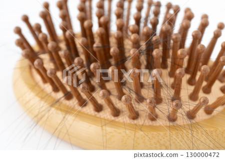 Close-up of a bamboo hairbrush with hair 130000472