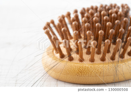 Close-up of a bamboo hairbrush with hair 130000508