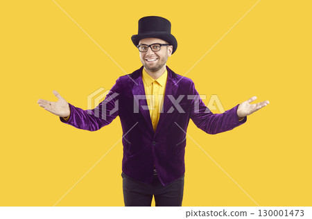 Entertainer in purple suit and top hat spreading his arms and welcoming you to show 130001473