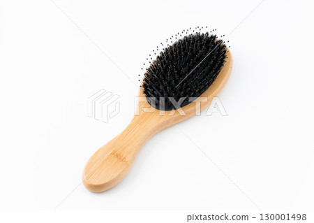 Pig bristle hairbrush on white background 130001498
