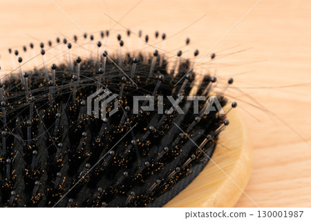 Close-up of a boar bristle hairbrush and loose hair 130001987