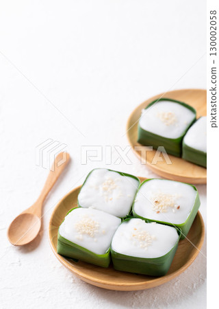 Traditional Thai dessert (Khanom Tako), Pudding with coconut cream topping in pandan leaf Traditional Thai dessert (Khanom Tako), Pudding with coconut cream topping in pandan leaf 130002058