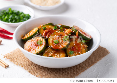 Korean cucumber salad (Oi muchim) in bowl on white background, Korean side dish Korean cucumber salad (Oi muchim) in bowl on white background, Korean side dish 130002064