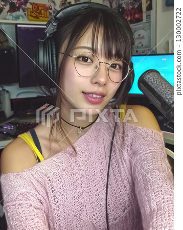 Portrait of an Asian female streamer wearing headphones 130002722