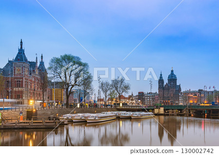 Amsterdam Netherlands, night city skyline at Amsterdam Central Station and Basilica of Saint Nicholas Amsterdam Netherlands, night city skyline at Amsterdam Central Station and Basilica of Saint Nicholas 130002742