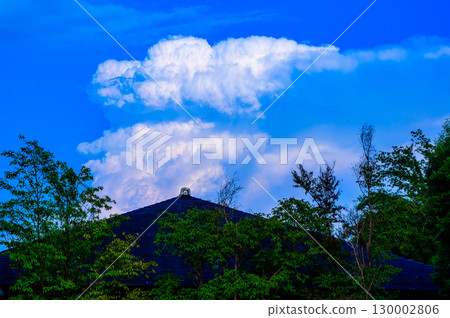 Triangular roof, cumulonimbus clouds and blue sky Triangular roof, cumulonimbus clouds and blue sky 130002806