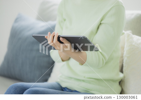 A woman who operates a tablet A woman who operates a tablet 130003061