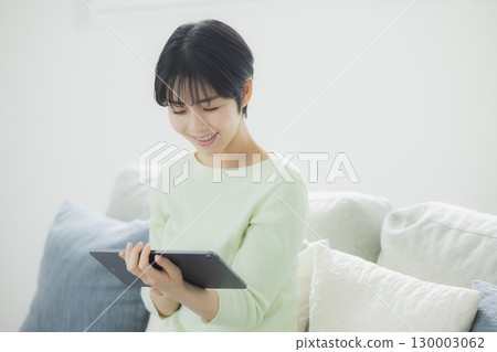 一個操作平板電腦的女人 一個操作平板電腦的女人 130003062