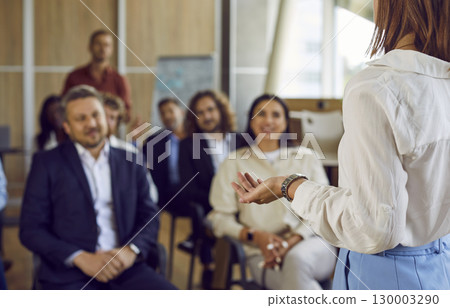 Business woman speaking on a meeting in office during a conference with company employees. Business woman speaking on a meeting in office during a conference with company employees. 130003290