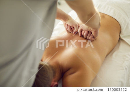 Rehabilitation spine massage closeup, exercise for patient, spinal therapy by physical therapist Rehabilitation spine massage closeup, exercise for patient, spinal therapy by physical therapist 130003322