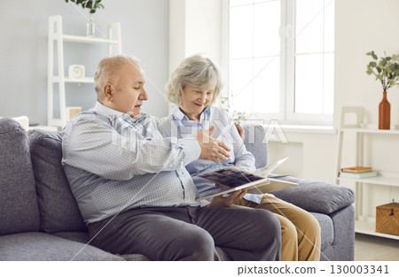Elderly Family Couple Looking At Photo Album Together Elderly Family Couple Looking At Photo Album Together 130003341
