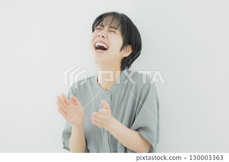 Young woman laughing out loud 130003363