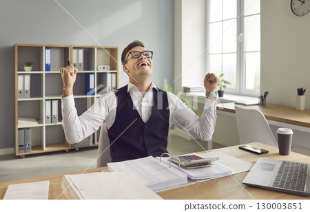 Positive Businessman Celebrating Success in Office Positive Businessman Celebrating Success in Office 130003851
