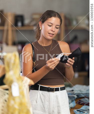 Woman choosing high-heeled shoes in a store 130003958