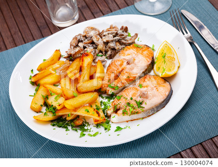 Salmon with potatoes and mushrooms is tasty dish in the kitchen Salmon with potatoes and mushrooms is tasty dish in the kitchen 130004074