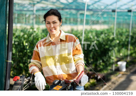 Portrait of Asian woman gardener with walking tractor Portrait of Asian woman gardener with walking tractor 130004159