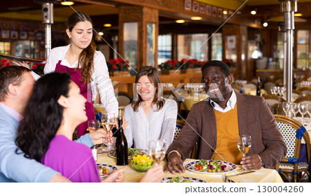 Couple on friendly meeting over dinner with wine in restaurant Couple on friendly meeting over dinner with wine in restaurant 130004260