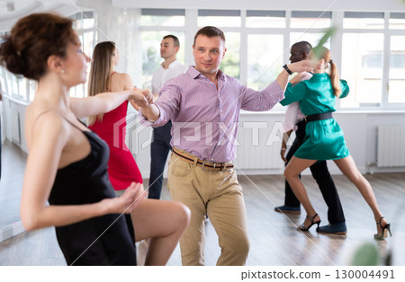 Woman dances incendiary boogie woogie with man partner during choreography lesson 130004491