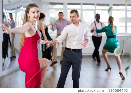 Man and woman practicing swing dance in dancing studio 130004492