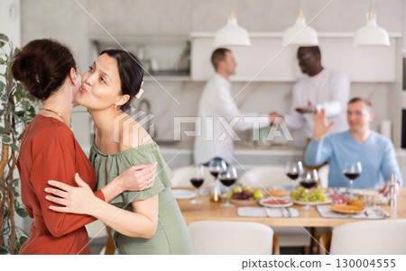 Two women greet each other when meeting Two women greet each other when meeting 130004555