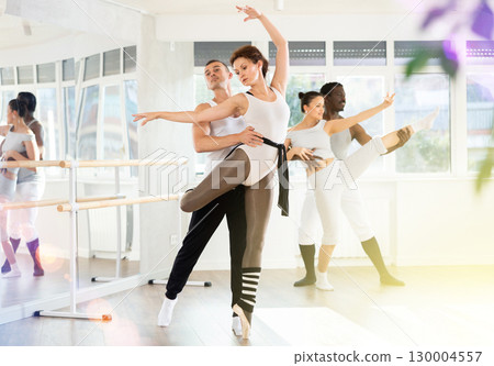 Man and woman perform paired ballet dance 130004557