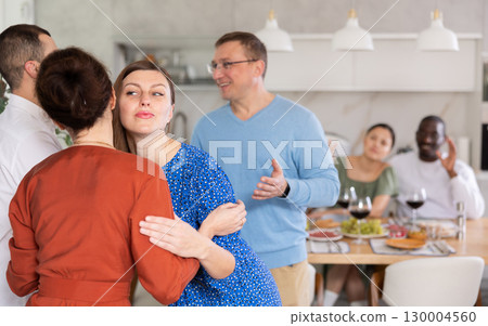 Married couples meet at home for festive dinner. Greet each other 130004560