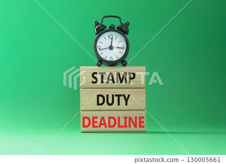 Stamp Duty Deadline symbol. Concept words Stamp Duty Deadline on wooden blocks. Beautiful green background with alarm clock. Business and Stamp Duty Deadline concept. Copy space. Stamp Duty Deadline symbol. Concept words Stamp Duty Deadline on wooden blocks. Beautiful green background with alarm clock. Business and Stamp Duty Deadline concept. Copy space. 130005661