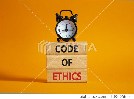 Code of ethics symbol. Concept words Code of ethics on wooden blocks with alarm clock. Beautiful orange background. Business and Code of ethics concept. Copy space. Code of ethics symbol. Concept words Code of ethics on wooden blocks with alarm clock. Beautiful orange background. Business and Code of ethics concept. Copy space. 130005664