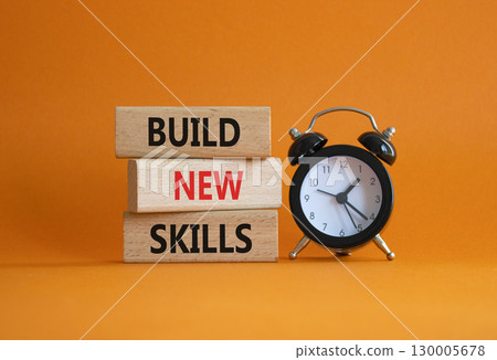 Build New skills symbol. Concept word Build New skills on wooden blocks with alarm clock. Beautiful orange background. Business and Build New skills concept. Copy space 130005678