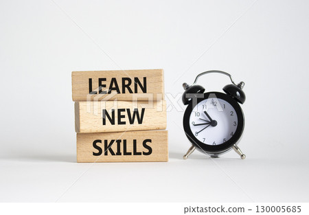 Learn new skills symbol. Concept words Learn new skills on wooden blocks. Beautiful white background with alarm clock. Business and Learn new skills concept. Copy space. Learn new skills symbol. Concept words Learn new skills on wooden blocks. Beautiful white background with alarm clock. Business and Learn new skills concept. Copy space. 130005685