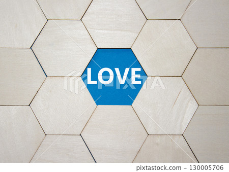 Love symbol. Concept word Love on wooden comb puzzle. Beautiful blue background. Business and Love concept. Copy space. 130005706