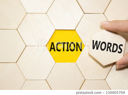 Action or words symbol. Concept word Action or words on wooden comb puzzle. Businessman hand. Beautiful yellow background. Business and Action or words concept. Copy space 130005709