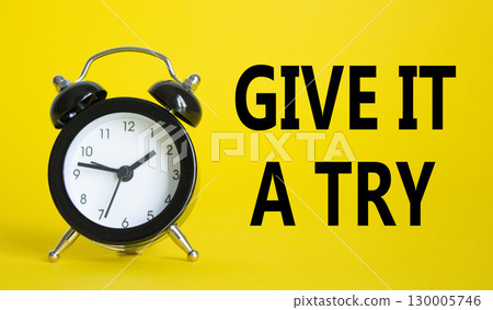 Give it a try symbol. Beautiful yellow background with alarm clock. Business and Give it a try concept. Copy space. 130005746