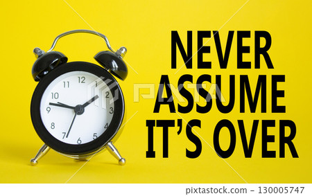 Never assume it is over symbol. Beautiful yellow background with alarm clock. Business and Never assume it is over concept. Copy space. 130005747