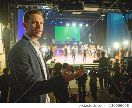 AI generated A visionary film director stands at the frame edge gesturing toward a busy movie set with cameras and crew. The dynamic scene captures the creative energy of filmmaking, storytelling AI generated A visionary film director stands at the frame edge gesturing toward a busy movie set with cameras and crew. The dynamic scene captures the creative energy of filmmaking, storytelling 130006608