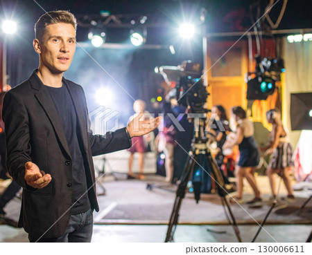 AI generated A visionary film director stands at the frame edge gesturing toward a busy movie set with cameras and crew. The dynamic scene captures the creative energy of filmmaking, storytelling AI generated A visionary film director stands at the frame edge gesturing toward a busy movie set with cameras and crew. The dynamic scene captures the creative energy of filmmaking, storytelling 130006611