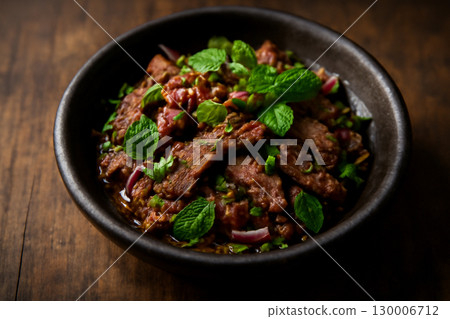 AI generated image of a Thai grilled beef salad with fresh mint, served in a dark earthenware bowl. The scene captures the dish bold colors and textures, evoking warmth and richness in a cozy 130006712