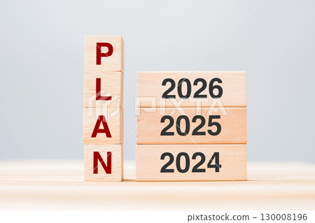 hand pulling 2026 block over 2025 and 2024 wooden building on table background. Business planning, Risk Management, Resolution, strategy, solution, goal, New Year New You and happy holiday concepts 130008196