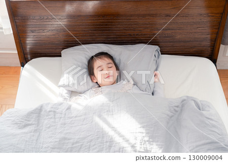Little girl sleeping soundly in bed Little girl sleeping soundly in bed 130009004