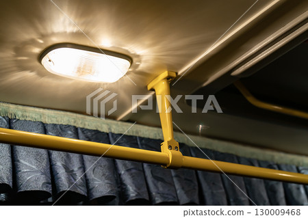 Lighting lamp on the ceiling of the bus above the handrail. 130009468