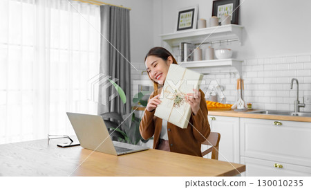 Young asian woman using computer laptop at home Young asian woman using computer laptop at home 130010235