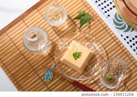 Refreshing summer Japanese cuisine: Egg tofu and condiments served in a clear glass dish. A refreshing and elegant dish image. Refreshing summer Japanese cuisine: Egg tofu and condiments served in a clear glass dish. A refreshing and elegant dish image. 130011208