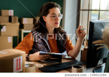 Woman working in a warehouse 130011260