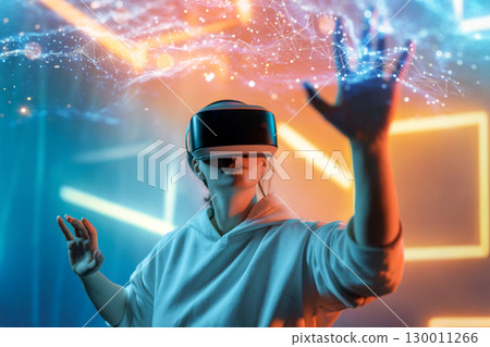 Woman with VR virtual reality goggles 130011266
