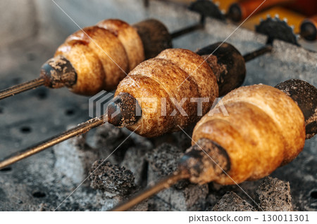 Street Food Trdelnik Baking on Charcoal. Traditional Pastry Experience Street Food Trdelnik Baking on Charcoal. Traditional Pastry Experience 130011301