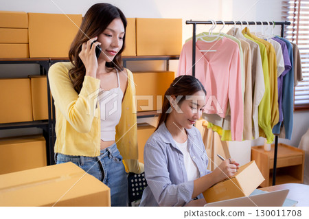 Two asian woman e-commerce startup in home office, two young entrepreneur management order. 130011708